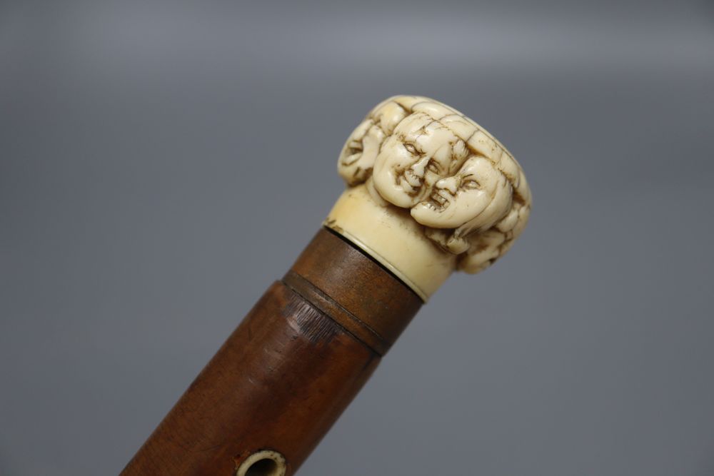 A late 19th century ivory mask handled walking cane, overall length 92cm